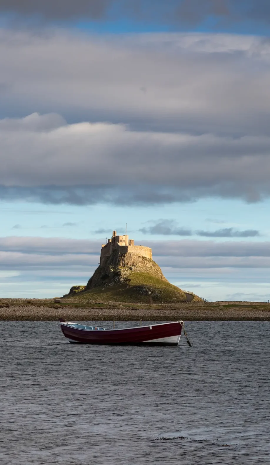Boat on water in front of Lindisfarne Castle.