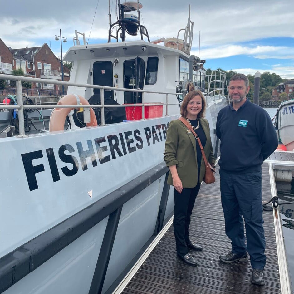 Karen Clark of North Tyneside Council visiting NIFCA, stood with Chief Officer in front of Fisheries Patrol vessel.
