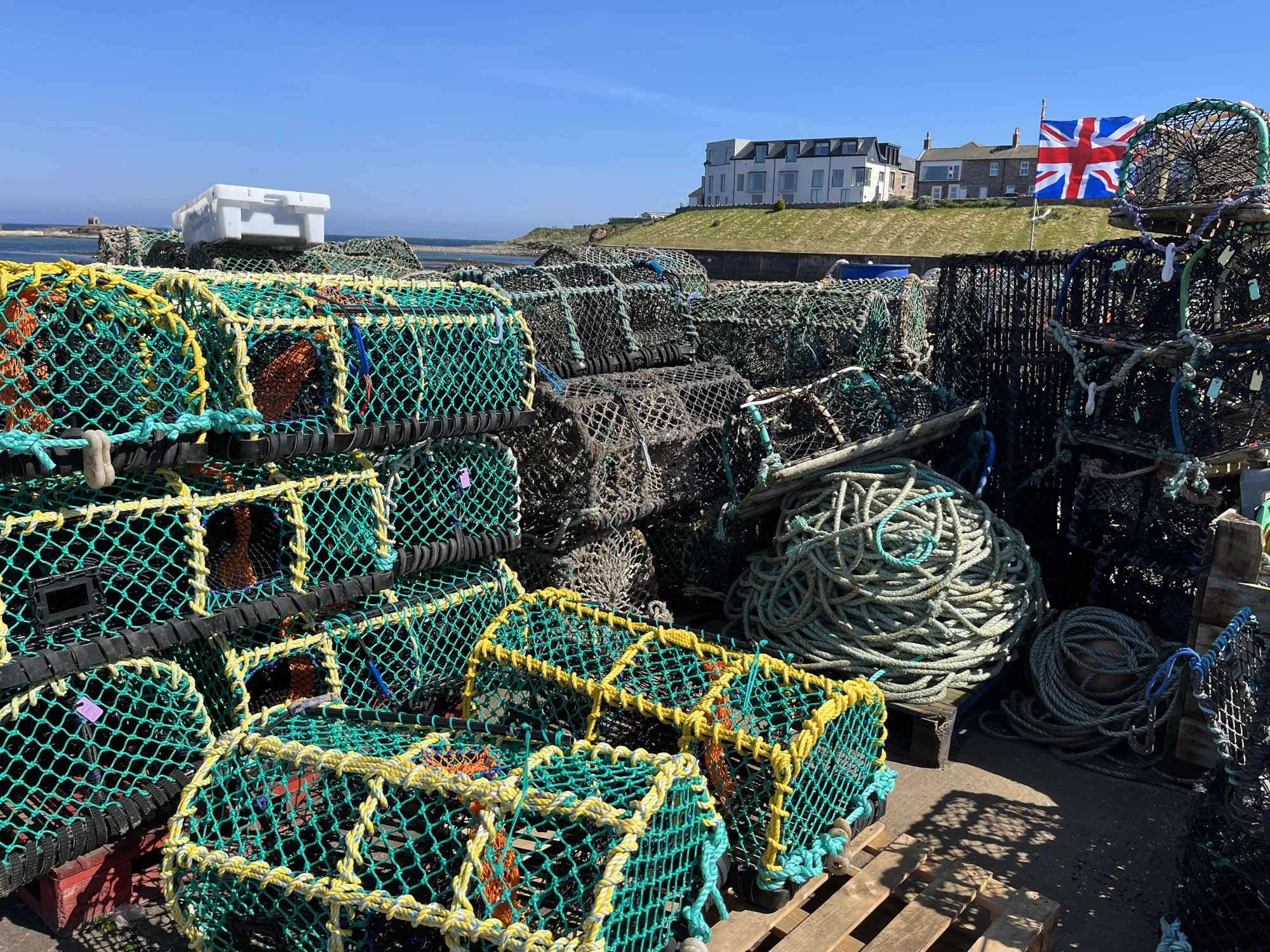Crab and lobster pots in sunshine on North Sunderland coast.