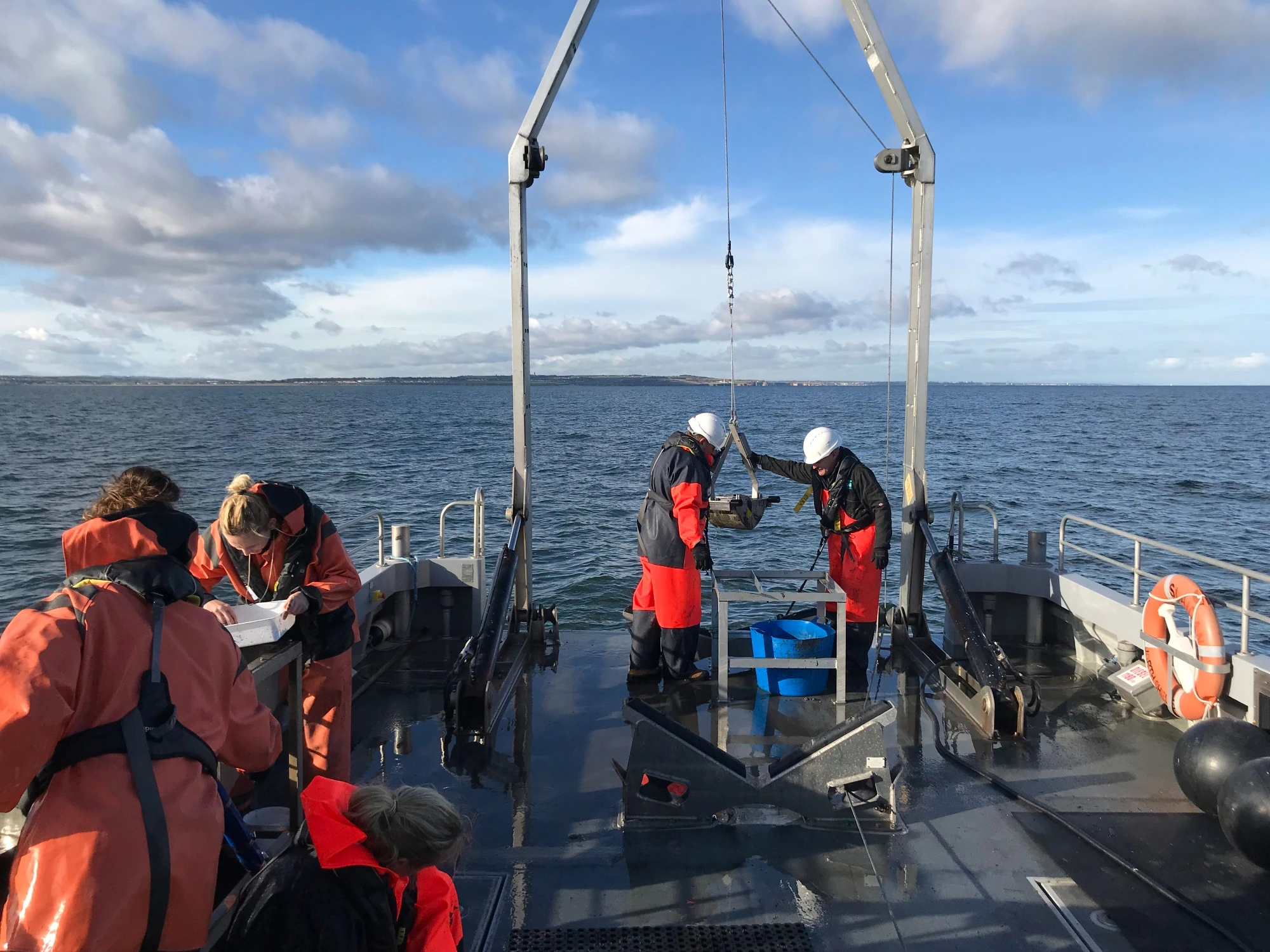 Newcastle University students on a boat doing survey work alongside NIFCA.